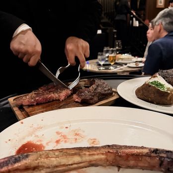 Hy's Steak House - Waiter cutting steak - Steakhouses Near Me - Honolulu, Hawaii