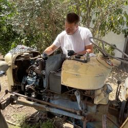 Symons Repair Service - Our Technician working on a vintage tractor and bringing it back to life after it sitting for years.