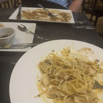Isola Bella Italian Eatery - My husband's dish (that is gone in this picture lol) was the chicken Marsala. My dish was the spaghetti carbanara. - Italian Near Me - Holmes Beach, Florida