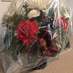 Christensen Floral & Greenhouse - Holiday arrangement still in the wrapping in how it arrives delivered.