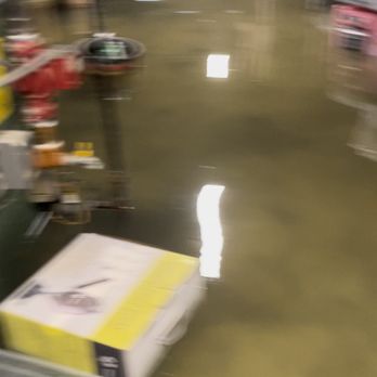 606 Junk Removal - An indoor area is flooded with water, covering the floor and partially submerging objects like a box and shelves. - Junk Removal & Hauling Near Me - Chicago, Illinois