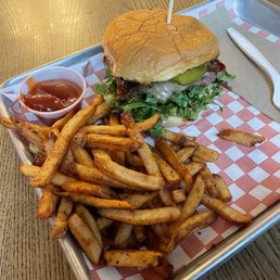 a burger and fries on a tray a burger and fries on a tray