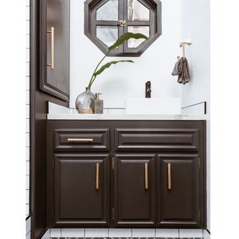 Built By Grundy - a bathroom with dark wood cabinets and white countertops - General Contractors Near Me Built By Grundy - a bathroom with dark wood cabinets and white countertops - General Contractors Near Me