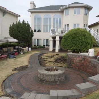 Dutch Yardworks - a brick patio and a fire pit - Landscaping Near Me