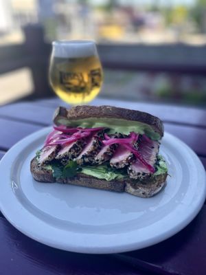 Photo of Latona Pub - Seattle, WA, US. Ahi Tuna Sandwich with pea jalapeño remoulade, pickled red onion, ginger vinaigrette and fine herbs on sourdough rye