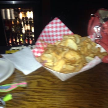 Dimarco's Bistro & Cantina - a wooden table with a basket of french fries and a glass of red wine - Salad Near Me - Uniontown, Pennsylvania