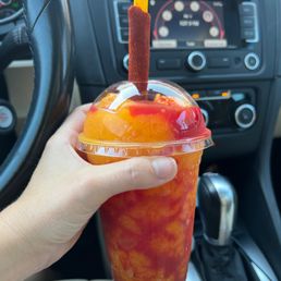 a person holding a drink in a car