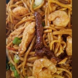 Lo Mein - A detailed image of house special lo mein with shrimp, chicken, and green onions, served in a takeout container. The dish includes stir-fried noodles, shrimp, chicken pieces, and chopped green onions, with a glossy sauce coating the ingredients. The presentation emphasizes the variety of proteins and vegetables in the dish, typical of Chinese takeout cuisine.
