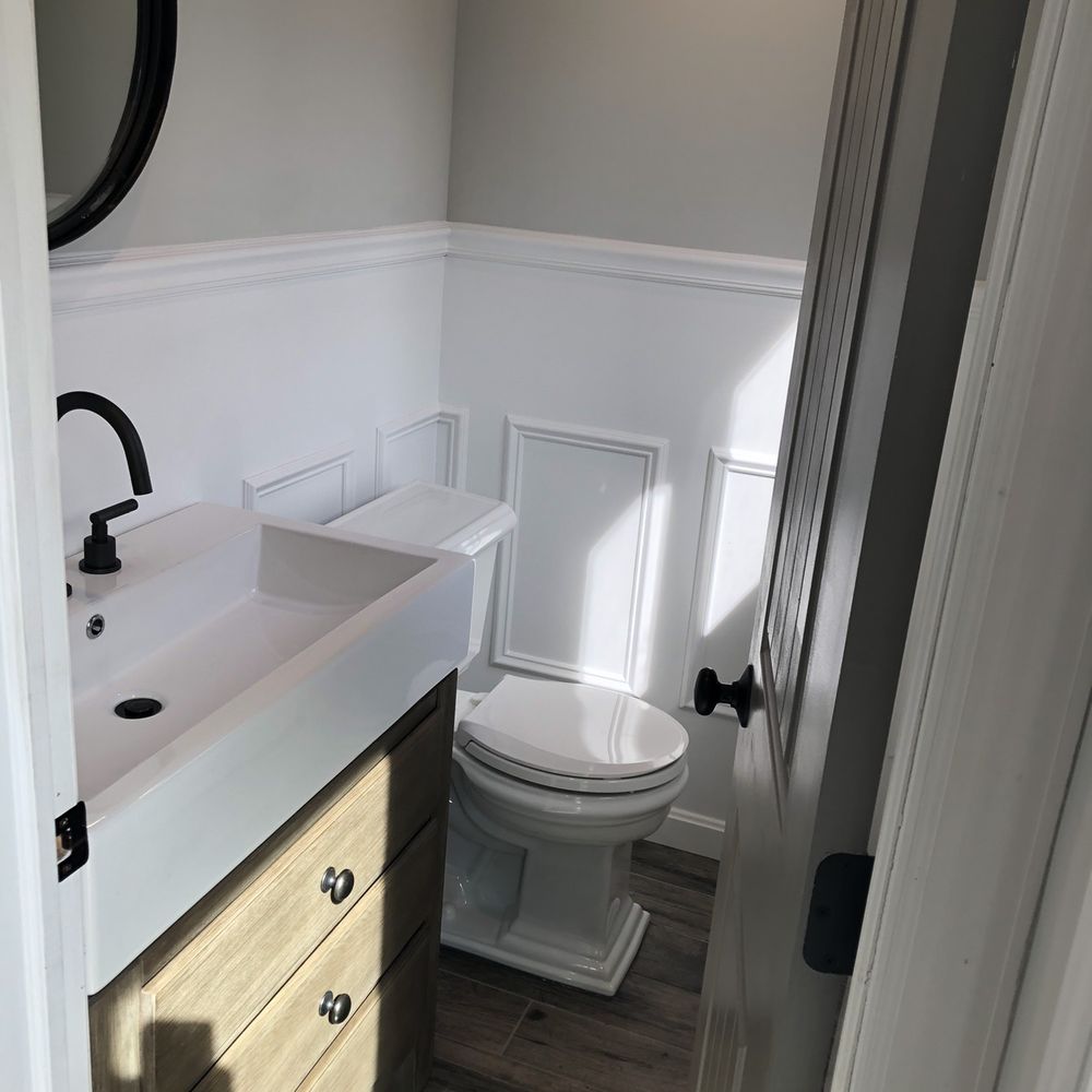 Renovate Right - a bathroom with a toilet and sink - General Contractors Near Me - Copiague, New York Renovate Right - a bathroom with a toilet and sink - General Contractors Near Me - Copiague, New York