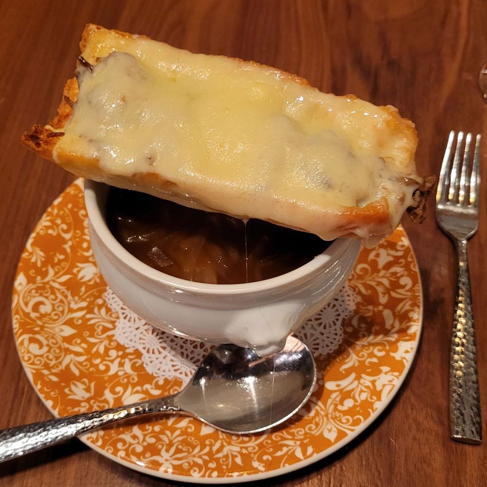 Ramsay's Kitchen - French Onion Soup. Note that the bread had braised beef underneath all the cheese. It is filling for an appetizer - New American Near Me - Las Vegas, Nevada Ramsay's Kitchen - French Onion Soup. Note that the bread had braised beef underneath all the cheese. It is filling for an appetizer - New American Near Me - Las Vegas, Nevada