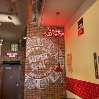 Jimmy John's - a brick wall with a sign that reads jimmy john's sub shop - Sandwiches Near Me - Diamond Bar, California