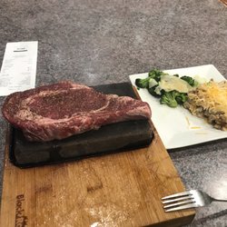Uptown Steakhouse - Ribeye on a hot stone with broccoli w/parmesan cheese and loaded mashed potatoes. Yummmm!!!