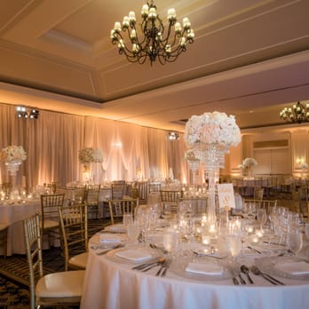 Asiel - Gorgeous centerpieces on their chandelier stands. Photo by Lin & Jirsa - Wedding Planning Near Me - San Jose, California