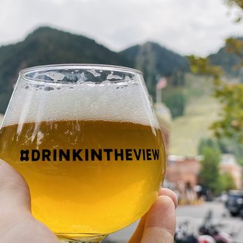 Aspen Tap - a person holding a glass of beer - Breweries Near Me - Aspen, Colorado Aspen Tap - a person holding a glass of beer - Breweries Near Me - Aspen, Colorado