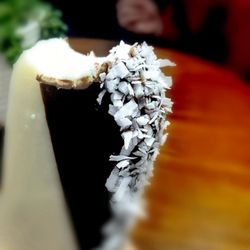 Sweet Pop Gelato - Coconut, filled with carmel, half dipped in chocolate, rolled in coconut.
