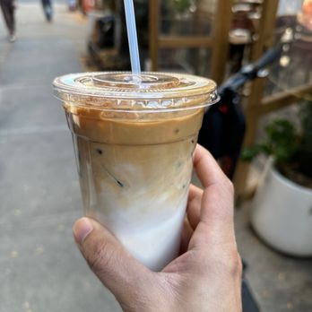 Birch Coffee - a hand holding a cup of coffee - Coffee & Tea Near Me - New York, New York