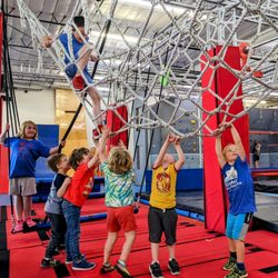 Ultimate Ninja Obstacle Gym - Ninja is for everyone even toddlers. Image shows toddlers enjoying the gym and trying to climb.