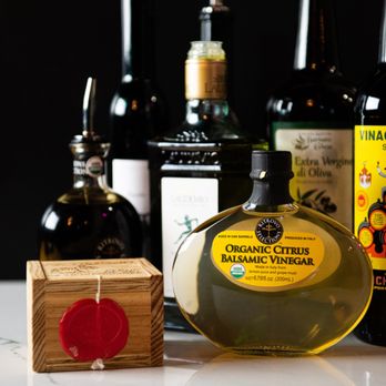 Cotto Belltown - a bottle of olive oil next to several bottles of wine - Italian Near Me - Seattle, Washington