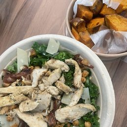 Dressed kale salad with a side of sweet potatoes