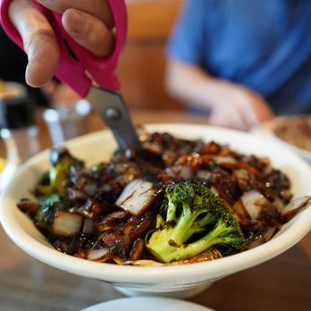Korean Noodle House - a person cutting broccoli - Korean Near Me - Flushing, New York