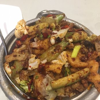 Frying Fish - Spicy Dry Pot with Fish. It's in a medium sized aluminum looking pot/bowl. Sizzling hot and tasty! - Szechuan Near Me - Bellevue, Washington