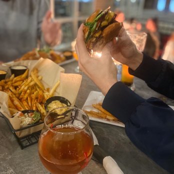 The Tap - a man eating a sandwich with fries and a glass of beer - Breweries Near Me - Indianapolis, Indiana The Tap - a man eating a sandwich with fries and a glass of beer - Breweries Near Me - Indianapolis, Indiana