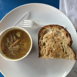 a bowl of soup and a sandwich on a plate