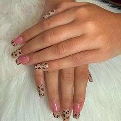 Naveana Nail Salon - Elegant square nails featuring soft pink tones and hand-painted leopard details.
