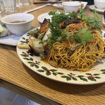 Mekong Village - Noodles with beef and vegetables in the front. Shrimp spring rolls in the back. - Vietnamese Near Me - Seattle, Washington