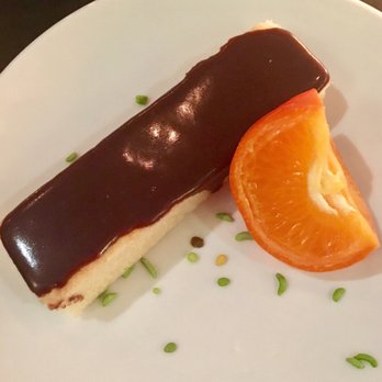 715 - Chocolate covered cake with clementine. It lacked flavor and wasn't worth the calories. - Italian Near Me - Lawrence, Kansas