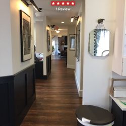 Brighter Days Dental - Main hallway inside Brighter Days Dental. Their decor is wood floors with industrial lighting, vintage decor in each room.