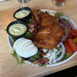 Salmon salad with bacon, blue cheese, hard boiled egg, and avocado dressing.