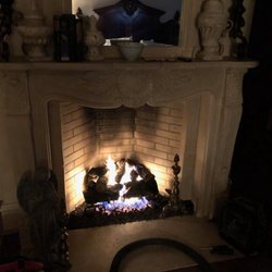 Certified Gas Systems - Remote controlled vented gas log set in a bedroom fireplace.