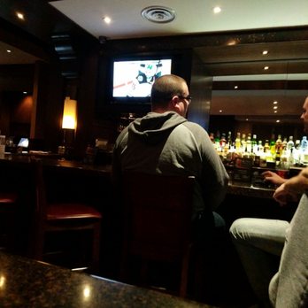 The Keg Steakhouse + Bar - two men sitting at the bar - Steakhouses Near Me - Red Deer, Alberta The Keg Steakhouse + Bar - two men sitting at the bar - Steakhouses Near Me - Red Deer, Alberta
