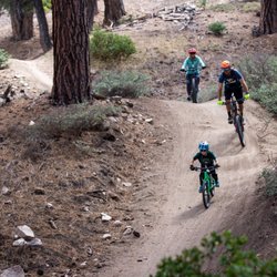 Snow Summit - A family of three riding a trail at Summit Bike Park.