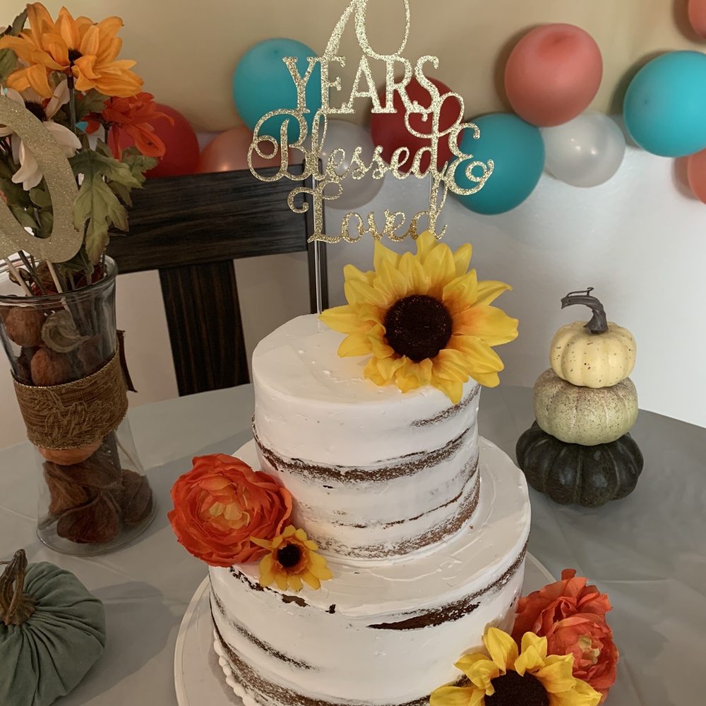 a wedding cake with sunflowers