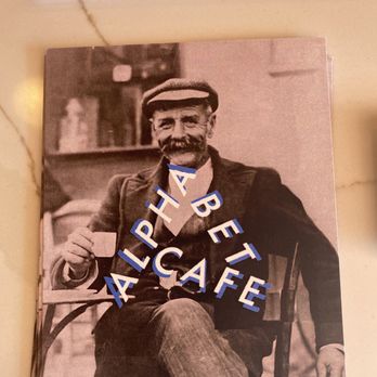 Cafe Alphabet - a man sitting in a chair - Coffee & Tea Near Me - Montreal, Quebec Cafe Alphabet - a man sitting in a chair - Coffee & Tea Near Me - Montreal, Quebec
