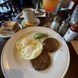 Eggs, Sausage, avocado and a sunrise mimosa Eggs, Sausage, avocado and a sunrise mimosa