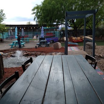 Gringo Theory Patio Bar - a wooden table and chairs - Bars Near Me - El Paso, Texas