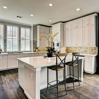 Bathwerks Houston - a kitchen with white cabinets and wood floors - General Contractors Near Me Bathwerks Houston - a kitchen with white cabinets and wood floors - General Contractors Near Me