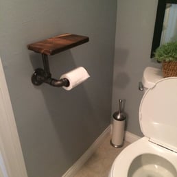Toilet roll holder + added shelf to leave your phone/tablet. Looks amazing. What a genius idea lol.