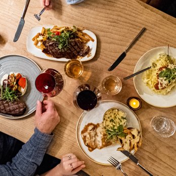 Barnwood - a group of people sitting at a table with plates of food - Salad Near Me - Niagara Falls, Ontario Barnwood - a group of people sitting at a table with plates of food - Salad Near Me - Niagara Falls, Ontario