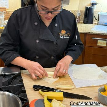 Pans on Fire - Anchalee demonstrated rolling a banana in rice paper. - Cooking Classes Near Me - Pleasanton, California