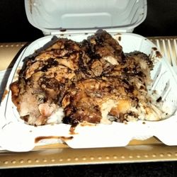 Blue Caribbean Bar & Lounge - Dark meat jerk chicken with rice and a side of barbecue sauce and curry sauce