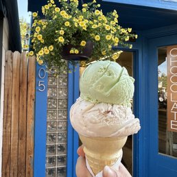 a hand holding a cone of ice cream a hand holding a cone of ice cream