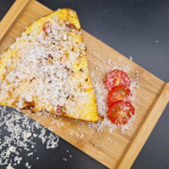 Apprentice Cafe - a slice of pizza on a cutting board - Coffee & Tea Near Me - Calgary, Alberta