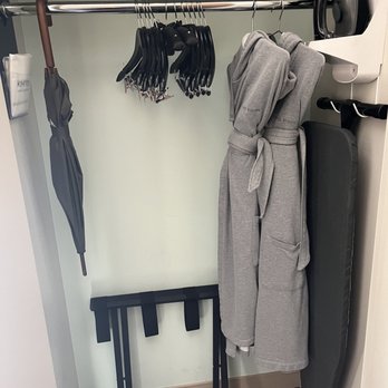 Kimpton Hotel Wilshire - Closet with umbrella, bath robes, luggage rack, flat iron and ironing board - Hotels Near Me - Los Angeles, California Kimpton Hotel Wilshire - Closet with umbrella, bath robes, luggage rack, flat iron and ironing board - Hotels Near Me - Los Angeles, California