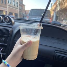 a hand holding a cup of coffee