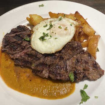 Cha Cha's Latin Kitchen - Brunch Special: Carne Asada Con Huevos $26.00 Marinated Skirt Steak / Cha Cha's potatoes / fried fresh egg / ranchero sauce - Bars Near Me - Brea, California