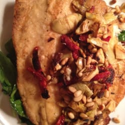 Brio Italian Grille - Pan seared Trout over a bed of crispy red potatoes and sautéed shrimp with roasted artichokes, sundries tomato, pine nuts